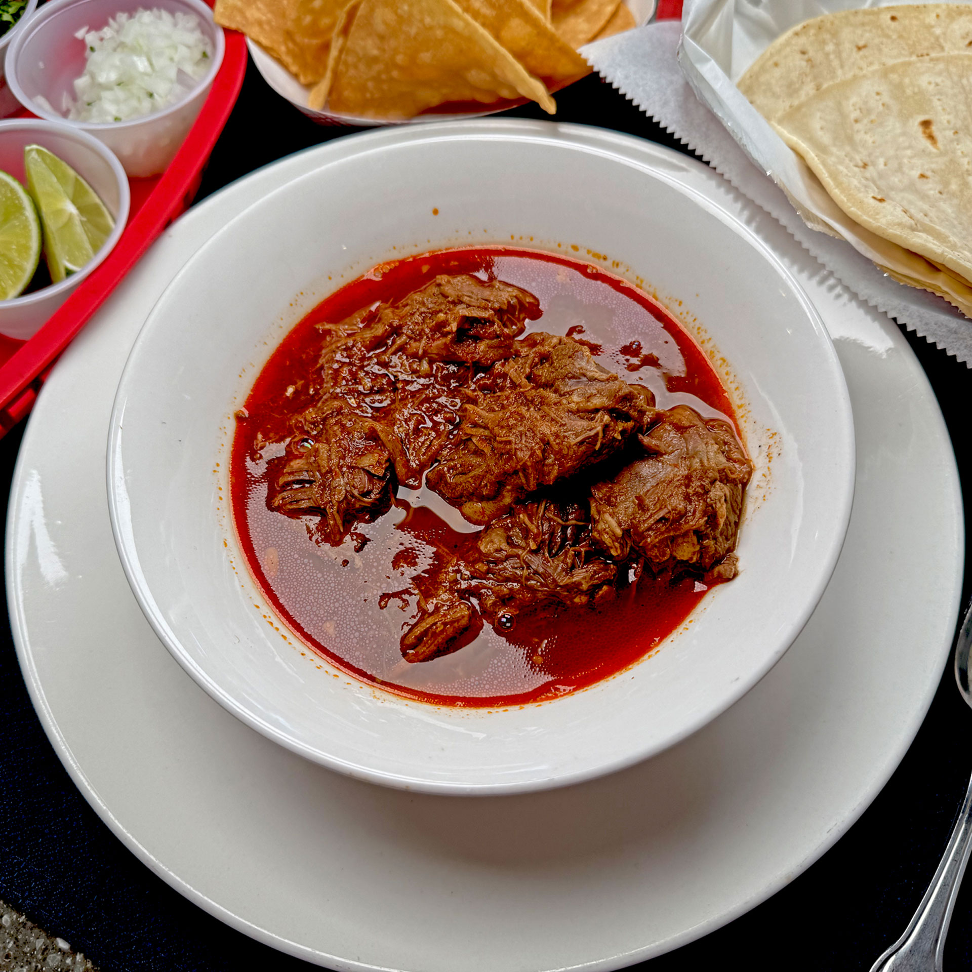 Dive into the soul-warming depths of our Birria Soup, a rich, aromatic broth brimming with tender, slow-cooked beef infused with a vibrant blend of traditional Mexican spices. Each spoonful bursts with smoky, tangy chiles, fresh cilantro, and a zesty lime finish, crafted from a cherished family recipe passed down through generations. Pure comfort in every sip! #BirriaSoup #MexicanTradition #FamilyRecipe #SoulFood #AuthenticMexican